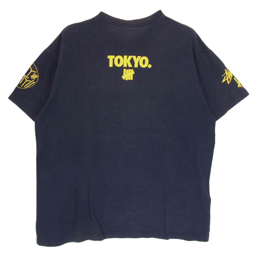 STUSSY ステューシー UNDEFEATED アンディーフィーテッド PLAY DIRTY プレイダーティ 半袖 Tシャツ ネイビー系 L【中古】