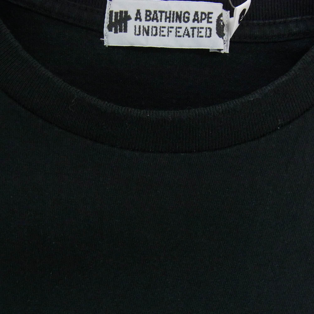 A BATHING APE アベイシングエイプ 001LTG731902X × UNDEFEATED アンディフィーテッド アームマルチ カモ ロゴプリント 長袖 カットソー ブラック系 M【中古】